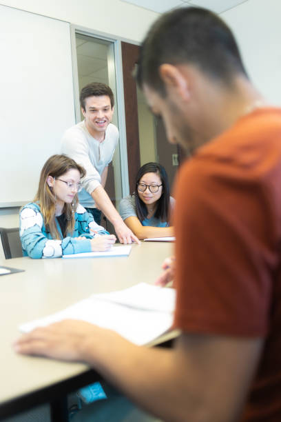istock Professor Working with Med Students - University Students in Conference Room Learning Medicine - Small Group Teaching - Study Room - Med Student Tutor 1440040152