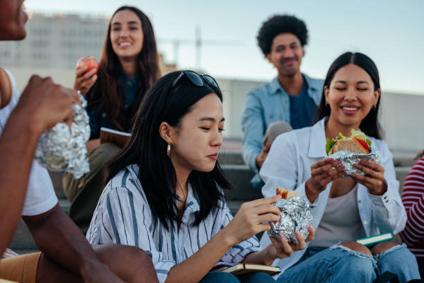 istock Young friends on lunch break outside. 1440040274
