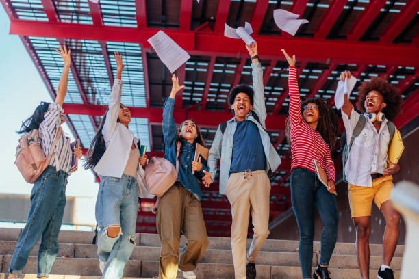 Happy students celebrate exam results. stock photo