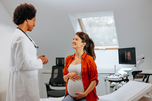 A pregnant woman is in the doctor's office for a regular visit.