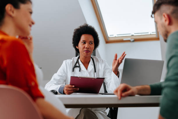 istock Obstetrician advising young parents to be. 1440040750