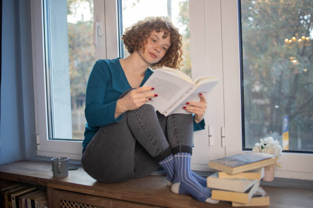 istock Woman relaxing and reading a book 1440041006