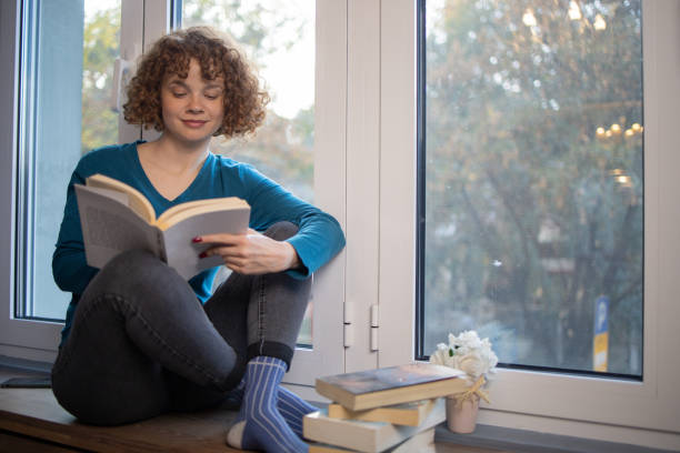 istock Woman relaxing and reading a book 1440041007