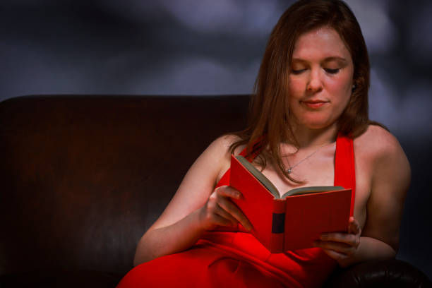 istock Young Woman Reading a Book 1440041153