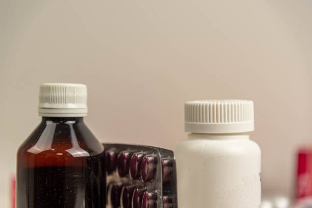 istock Pills and medicine bottles on neutral background 1440042227