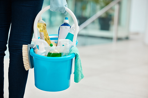 Cleaning container products with cleaner person hand in a office building or corporate business. Service worker scrub, gloves and liquid soap for disinfectant, sanitize and hygiene in the workplace
