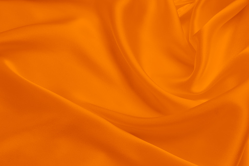 Wrinkled bright orange knitted fabric for the background