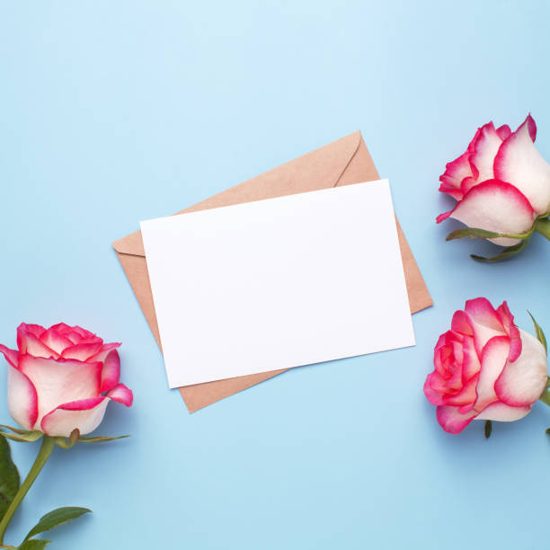 istock Mockup invitation, blank greeting card and rose flowers. Flat lay, top view. 1440046941
