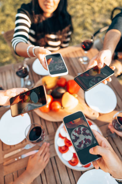 istock taking photos to the food 1440049582