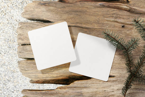 istock Clean minimal square flyer mockup on wooden bench with conifer background 1440050125