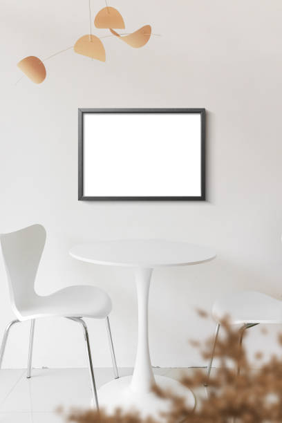 istock Clean minimal frame mockup on the white wall with table and chairs 1440050670