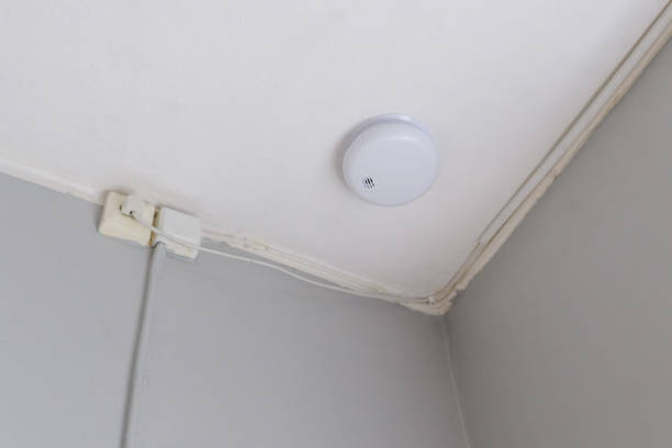istock Smoke detector and alarm on bedroom ceiling 1440051200