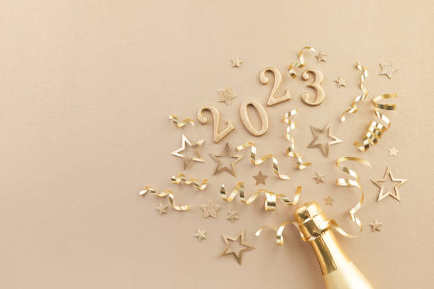 christmas and new year background with golden champagne bottle, party decorations, confetti stars and 2023 numbers. - confetti new years day new year christmas imagens e fotografias de stock