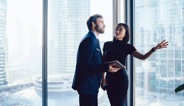 istock Modern diverse business partners talking in office 1440053320
