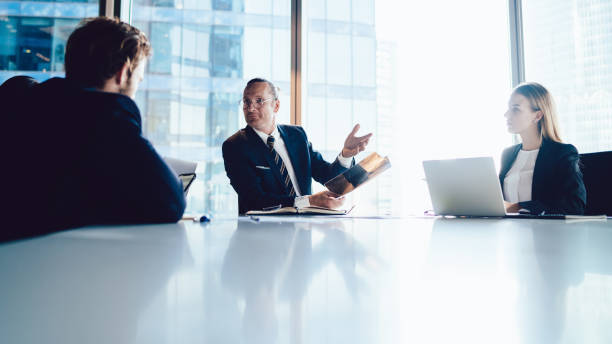 istock Executive male talking to colleagues on briefing in office 1440053369