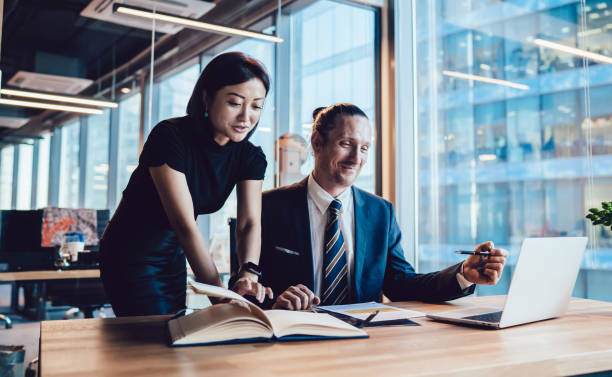 istock Content diverse colleagues planning project together in office 1440053934