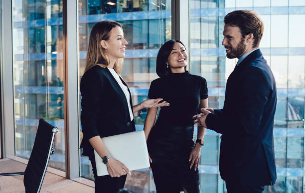 istock Smiling diverse business people talking to each other in modern office 1440053971