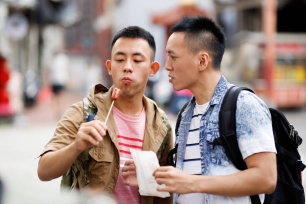 istock Two men enjoying street food 1440056462