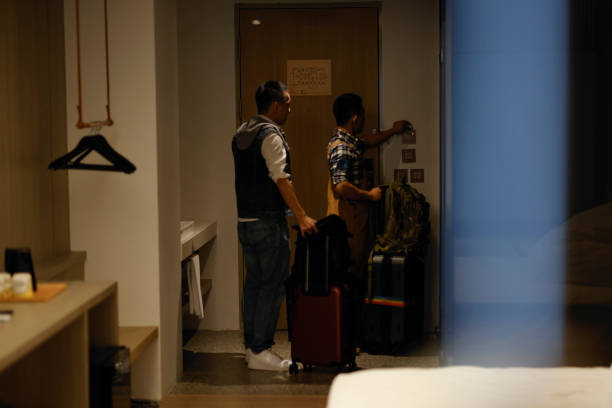 istock Two men prepare to check out and continue their journey 1440056491