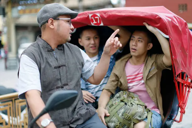 Two men on a tricycle ride around Changhua's Lukang Street and take a guided tour of the local scenery and culture