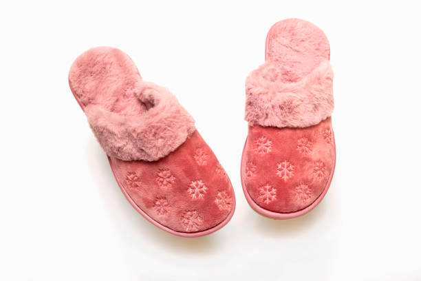 istock Pink warm women's slippers on a white background 1440057318