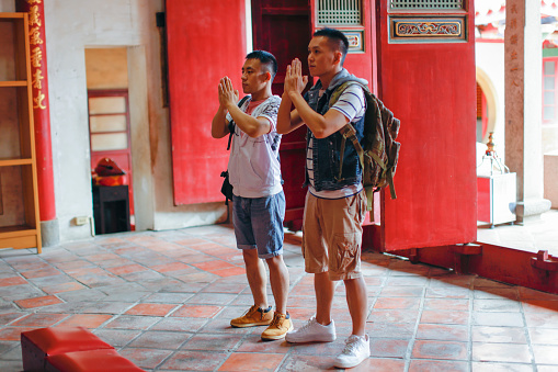 Two men travel in temples and pay homage to worship with incense