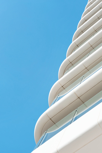 minimalist composition of balconies of a white and red modern office building in Barcelona city