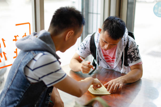 Two men order meals and enjoy delicious food at a snack bar in Lukang, Changhua, Taiwan
