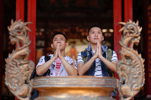 Two men travel in temples and pay homage to worship with incense