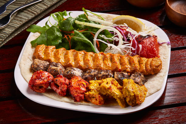 istock Chicken Mixed Grills platter with salad, lemon, bread served in dish isolated on table side view of middle east food 1440058230