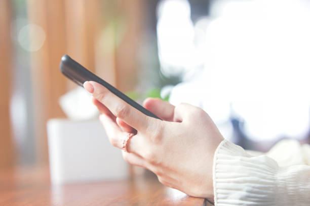 istock woman's hand using mobile phone for shopping and chatting 1440059504