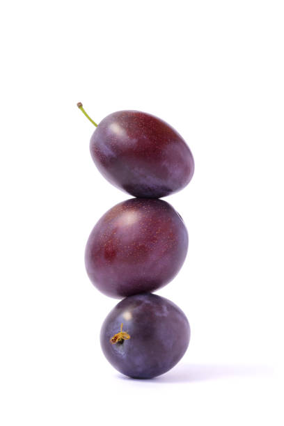istock Ripe balancing plum on white background. Equilibrium food balance. 1440061523