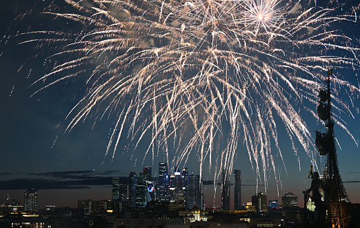 July 29, 2022, Moscow, Russia. Fireworks over the monument to Peter the Great and Moscow City skyscrapers on a summer evening.