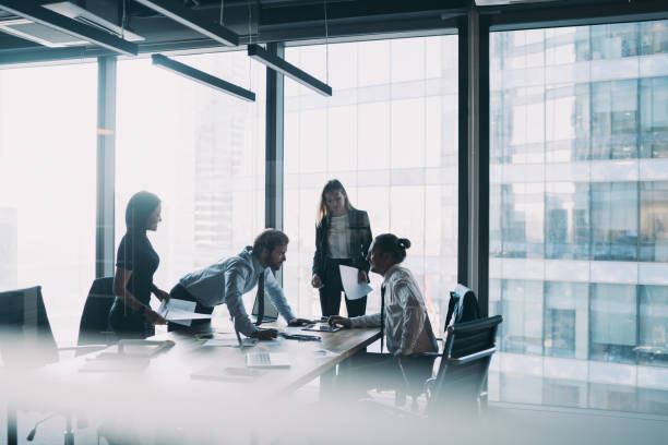 istock Male and female professionals teamworking during brainstorming cooperation on paper documents, group of diverse employers discussing corporate investment of firm capital briefing in conference room 1440061911