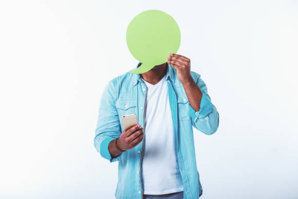 istock Afro American with speech bubble and gadget 1440063383