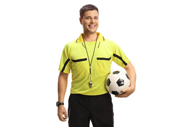 istock Football referee holding a ball and smiling at camera 1440065499