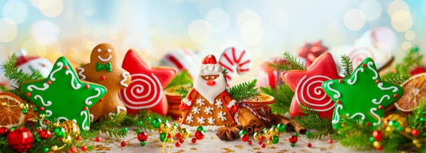 christmas composition with christmas handmade gingerbread cookies, winter spices and holidays decorations. banner. - gift orange green package imagens e fotografias de stock