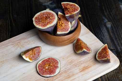 Ripe figs cut into pieces, cut into pieces ripe figs on the table