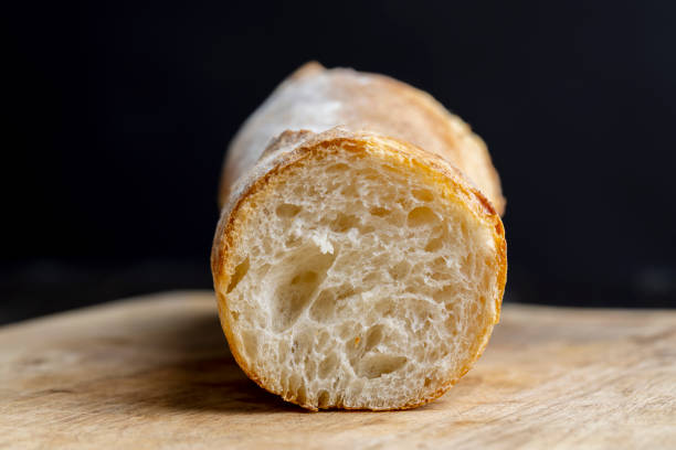 Sliced wheat baguette on a board