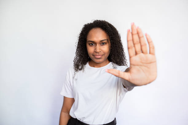 istock Portrait of confident young woman making stop gesture 1440066406