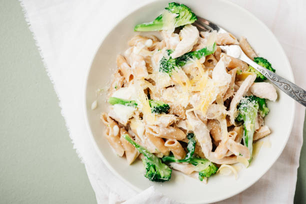 istock Whole grain penne pasta with chicken and green vegetables. 1440067327