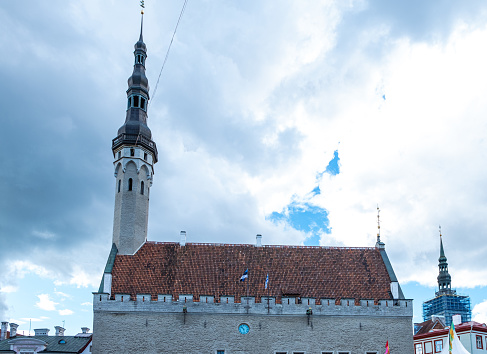 07/06/2022 Estonia Tallinn. Tallinn city hall building with red tiled roof and spire.