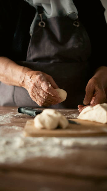 istock Close-up elderly woman making pizza dough 1440069563