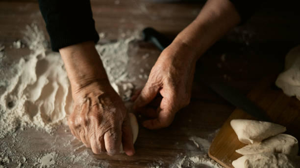 istock Close-up elderly woman making pizza dough 1440069564