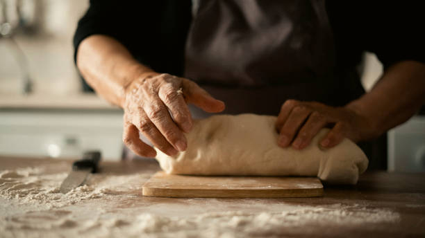 istock Close-up elderly woman making pizza dough 1440069565