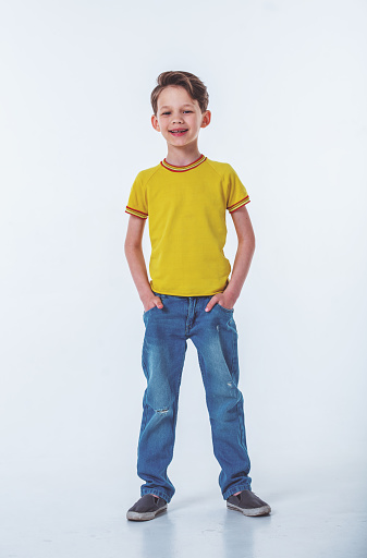 childhood, gesture and people concept - portrait of smiling boy pointing finger to camera over grey background