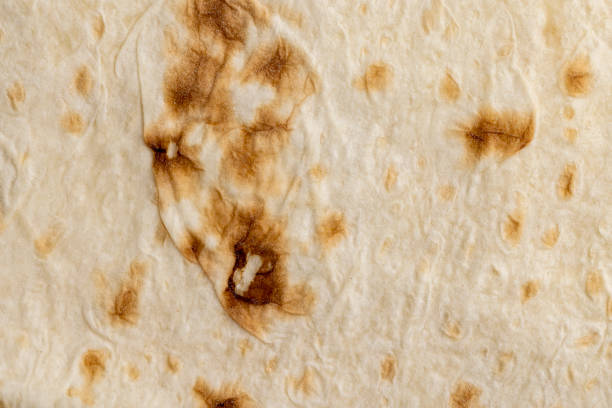 istock Wheat pita bread with dark spots 1440070865