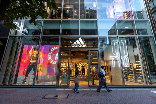 Tokyo, Japan - September 3, 2022 : Pedestrians walk past Adidas in Ginza, Tokyo, Japan.
