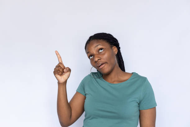 istock Funny woman grimacing, pointing up 1440072352