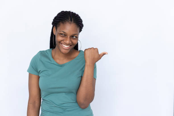 istock Happy woman pointing aside 1440072867